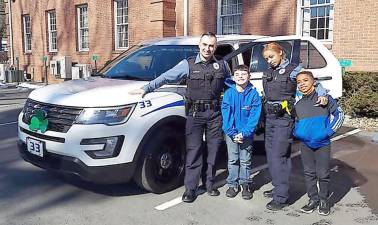 Milford police officers Brandan Gargan and Lorin McFarlane with two nine-year-olds, Vincent Callanan and Rahiym Reed (Officer McFarlane's son)