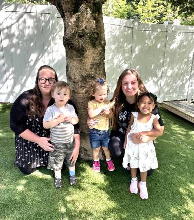Green Trees Early Learning Center staff with three students.