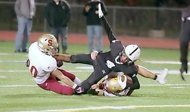 Delaware Valley ball carrier Jawon Foushee is tackled by Scranton defenders in the first half. Foushee caught one touchdown pass.