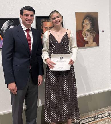 Rep. Rob Bresnahan stands with Delaware Valley High School eleventh grader Maya Zhivkovich, whose painting, “A Mother’s Bond” (pictured on the wall to her right), took third place in the Congressional Art Show for the congressman’s district. Provided photo.