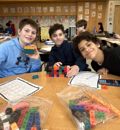 DVES students work with unit cubes to learn about volume.