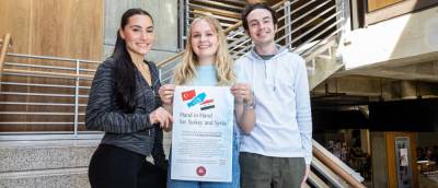 Francesca Palmeri, Emily Egan, and Matthew Feeley hold a flyer to promote ESU’s chapter of the PRSSA’s fundraiser “Hand in Hand for Turkey and Syria.”