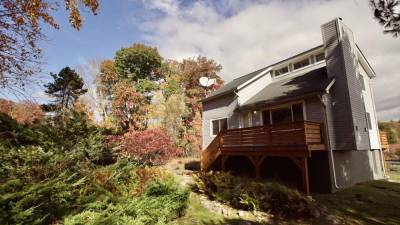 Lakefront home with private dock surrounded by nature