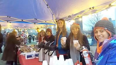 Revelers at last year's tree lighting stay warm with hot chocolate.