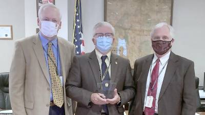 Pike County Commissioners Ronald Schmalzle, Matthew Osterberg and Steven Guccini accept the Governor’s Awards for Local Government Excellence in the Building Community Partnerships category on behalf of the county’s Opioid Task Force, Tick Borne Diseases Task Force, and Reentry Coalition.(Photo provided)