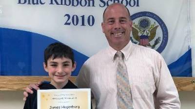 James Michael Hagenburg with his certificate and his principal, Dr. Peter Ioppolo