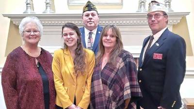 First row (from left): Guyette Calles, District Auxiliary President; Autumn Baker; Debra Baker; Rick Ellis, District Commander; second row: Gregory Protsko, Post 8612 Commander, Milford