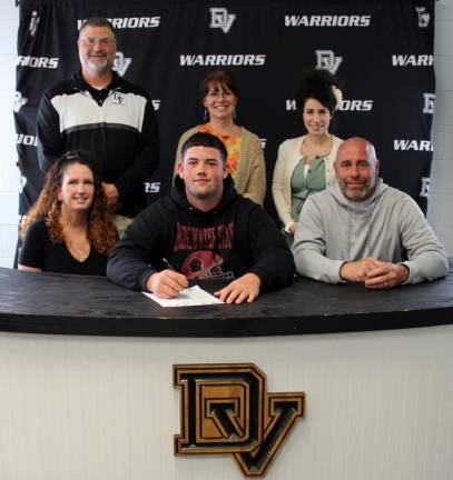 Pictured in front: Senior Delaware Valley senior Justin Hernandez is flanked by his mother, Stefanie (left), and his father, Andre. Behind them, from left to right, are: Head football coach and assistant track coach Keith Olsommer, guidance counselor Molly Blaut and high school principal Dr. Nicole Cosentino. Photo provided by Leslie Lordi/Delaware Valley School District.