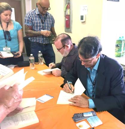 George Anderson (left) and Dr. Eben Alexander of the Life and the Afterlife panel had a line going out the door for their book signing.