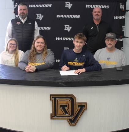 DVHS senior Keegan Samson signs a letter or intent to Centenary University as (bottom row l-r) his sister Chelsea Samson, mother Lisa Samson, father Andrew Samson, Eastern Pike coach Chris Decker (rear left) and varsity head coach Aaron Stark (rear right) look on.