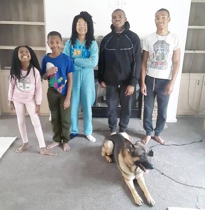 The Polhill children (from left): Eva, 8; Miles, 9; Imani, 13; Noah, 14; and Ray Jr.; 16; with Ceasar (Photo by Naeemah Polhill)