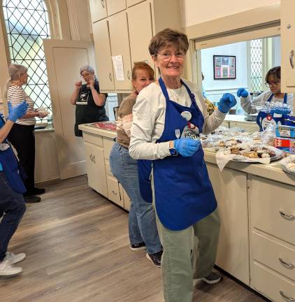 Volunteers Emily &amp; Donna prepare dessert platters at the May lunch.