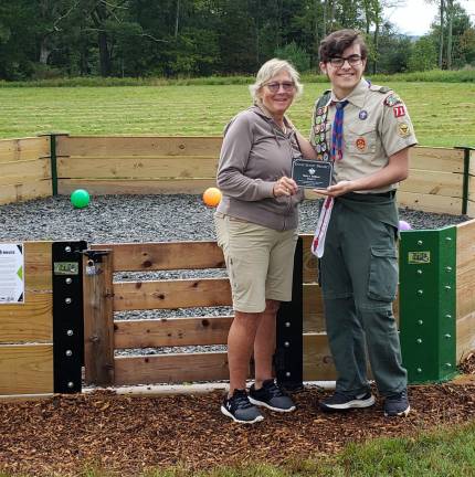 Mrs. Maida, physical education teacher at Shohola Elementary School, receives from Life Scout Mark DeBlock a plaque dedicating his Eagle project to her and to the students.