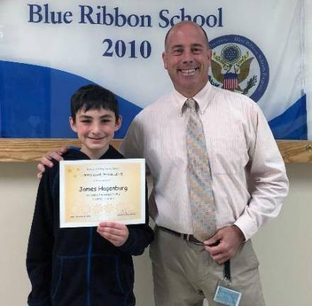 James Michael Hagenburg with his certificate and his principal, Dr. Peter Ioppolo