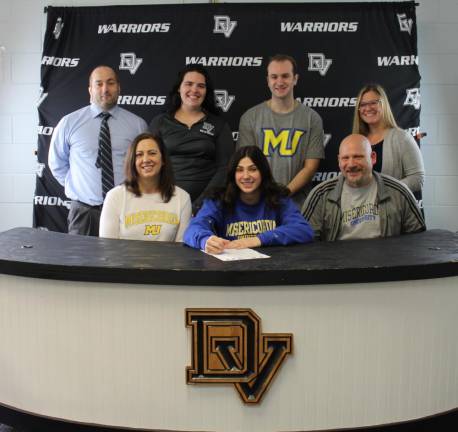 DVHS volleyball captain Olivia Conza seated with her parents, Lisa and James Conza and with (standing l-r) school assistant principal Lou DeLauro, head volleyball coach Karley May, her brother James Conza, and guidance counselor Crystal Ross.