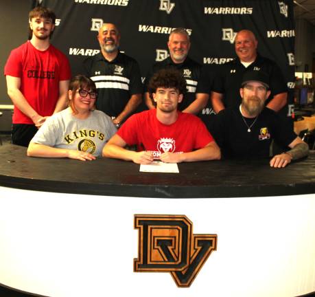 Riley Smith signs his letter of intent to play lacrosse at King’s College. Front row (L-R): Angela Smith, Riley Smith, and Christopher Smith. Back row (L-R): Brother Brody Smith, head coach Dan Gonzalez, assistant coach Jesse Jayne, and former coach Jeff Krasulski.