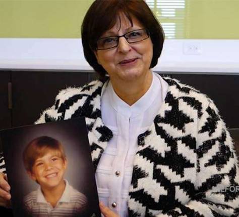 Darla Dickson in 2015 holds a photo of her son Bryon (File photo by Preston Ehrler)