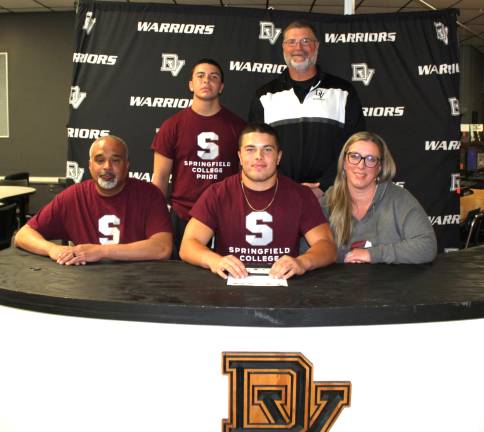 Justin Estevez will continue playing football at Springfield College. Front row (L-R): Faron Soto, Justin Estevez, and Melissa Soto. Back row (L-R): Brother Devin Estevez and head coach Keith Olsommer