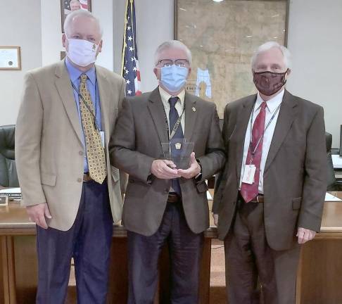 Pike County Commissioners Ronald Schmalzle, Matthew Osterberg and Steven Guccini accept the Governor’s Awards for Local Government Excellence in the Building Community Partnerships category on behalf of the county’s Opioid Task Force, Tick Borne Diseases Task Force, and Reentry Coalition.(Photo provided)