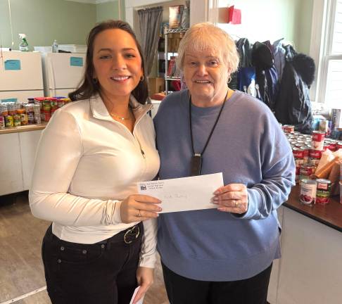 Shannen Borris oPeople Helping People presents a check to Nancy Potter of the Ecumenical Food Pantry of Pike County.