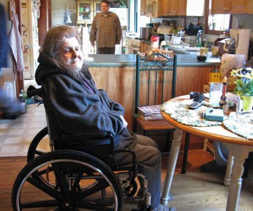 Doris France in her kitchen, with son David in the background (Photo by Ginny Privitar)