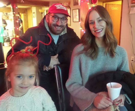 Frances McTee, wearing antlers that she made at the crafts table, with her parents, Zack and Laureen (Photo by Frances Ruth Harris)