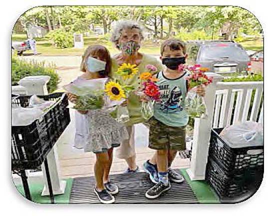 Linda Pinto and helpers deliver flowers and vegetables from the Milford Garden Club (Photo provided)