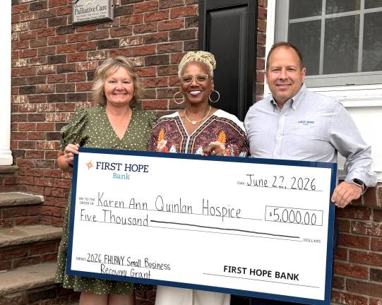 Daniel Beatty, president, CEO and board chair of First Hope Bank, and Deena Smith, senior vice president and commercial loan officer at First Hope Bank, present check to Lee Ellison, executive director of Karen Ann Quinlan Hospice.