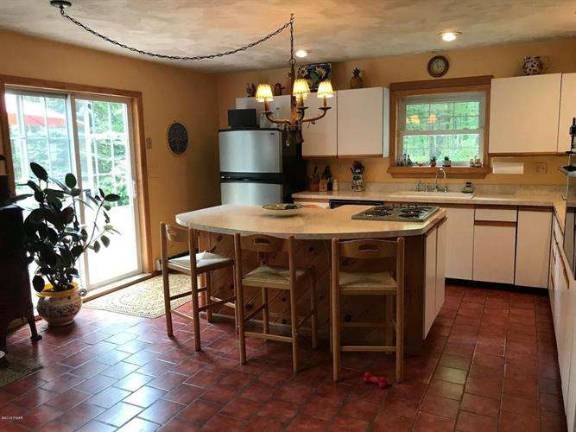 Enjoy woods and water in this two-story country farmhouse