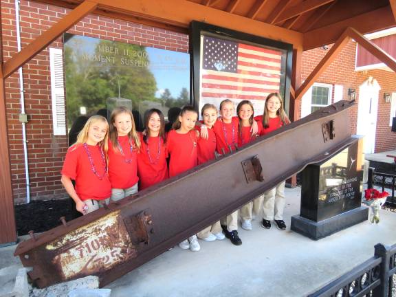 The reporters outside by an actual beam from the Twin Towers.