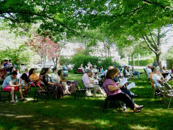 Those present listen while the names of the persons in whose honor the butterflies were released are read out aloud.