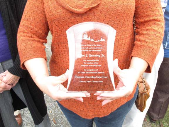Al Greening's plaque being displayed by a member of the Greening family.