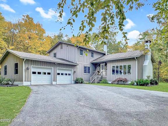 Privately set, renovated home has land, lake access and no dues