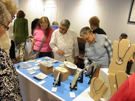 Visitors look over the creations of local artists at the Pike County Arts and Crafts Show (Photo by Anya Tikka)