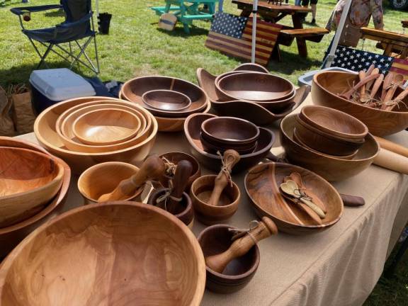 Vendors with bowls, a wooden table, and a wooden flag at the Festival of Wood, sponsored by the Grey Towers Heritage Association
