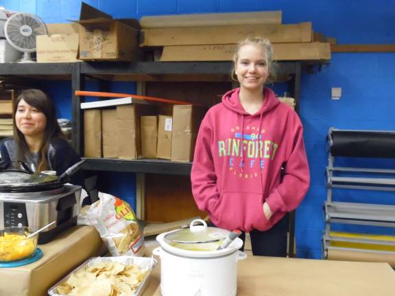 Maryanne Laurea and Devyn Walfer, both 17 and students at Delaware Valley High School, served soup at the recent "Empty Bowls" sale to feed the hungry. For more about the event please turn to page 2 (Photo by Anya Tikka)