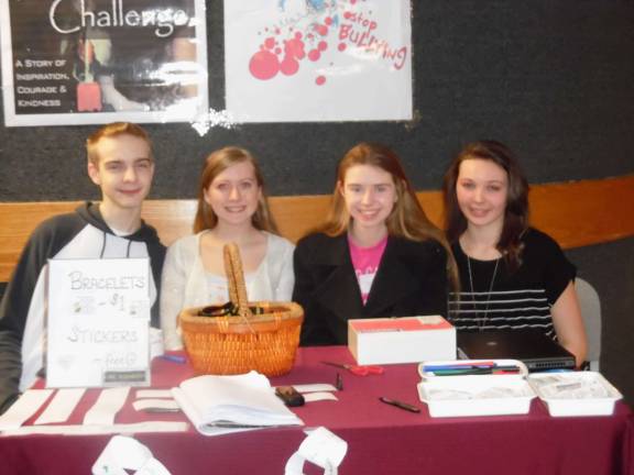 Representatives of Rachel's Challenge Club at the DV sit at the entrance to the auditorium. From left, Jimmy Stevens, Jamie Wintermute, Bryonna Klimkiewicz and Cheryl Lannon.