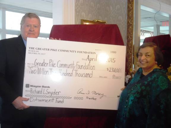 Jim Pendrati, chair of the Greater Pike Community Foundation, and Ann Morey, trustee, hold a display check for $2.3 million. (Photo by Anya Tikka)