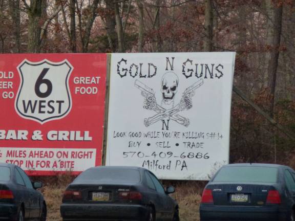 A billboard for the Gold-n-Guns shop in Milford, PA. The shop has seen sales of assault-style weapons increase in the weeks after calls for gun control and the shooting of 20 first-graders in Connecticut. (Photo by Pamela Chergotis)