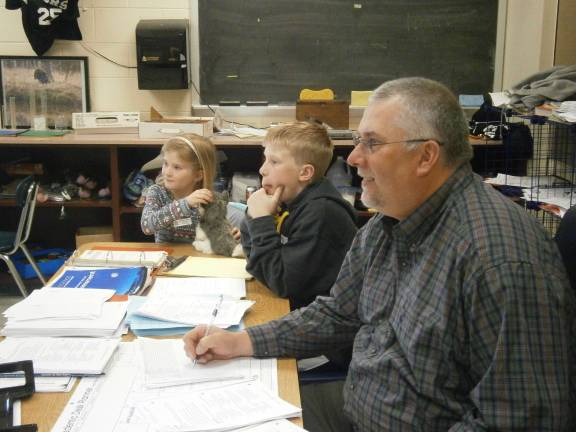 Dacyn and Sawyer Koretz help check student work on the board (Photo provided)