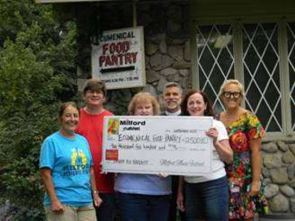 Milford Music Festival volunteers present $2,500 raised from Share the Harvest to food pantry director Nancy Potter and Father Van of the Church of the Good Shepherd