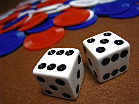 Pair of dice in front of poker chips.