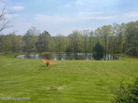 Luxury stone manor house has a private pond and pool