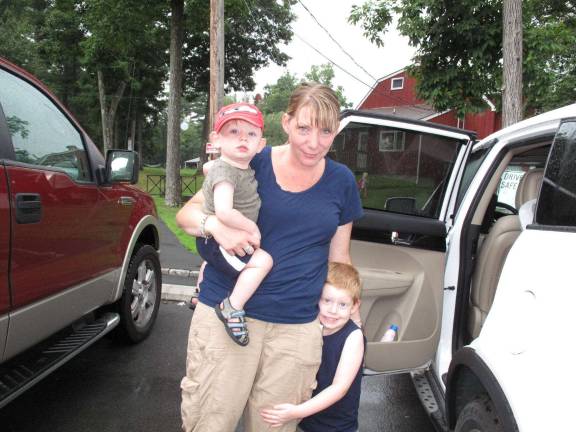 Milford Hill Learning Center client Melissa Theodore and her two children, 14-month- old Jacob and 4 1/2-year-old Justin leaving the Center. Melissa said she'll take a leave of absence from work while she tries to find another suitable day care center.