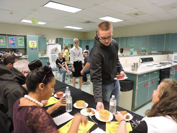 John Helms serves Raycharlyn Krasulski and Chelsea Shatt (Photo provided)