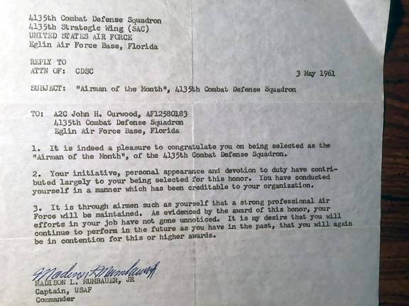 A May 1962 letter from Commander Madison L. Mumbauer Jr. commending John H. Curwood as Airman of the Month