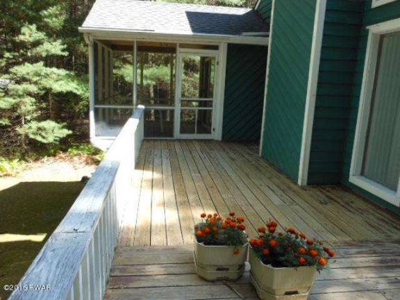 Dingmans home surrounded by trees has lake access