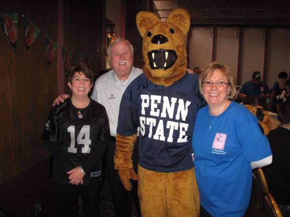 From left: Catherine and Paul McGloin, the Penn State Mascot, and Kathy Zielinski of the Children's Advocacy Center, the "Tailgate" chair (Photo by Jerry Goldberg)