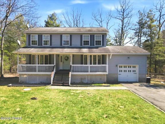 Enjoy country living and lake access in a spacious four-bedroom home