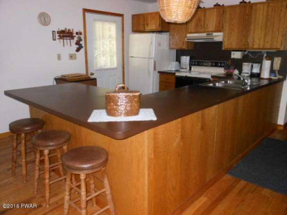 Dingmans home surrounded by trees has lake access